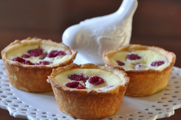 "Ricotta cheese tarts in cornmeal crusts with tart raspberries for a delicious contrast."
