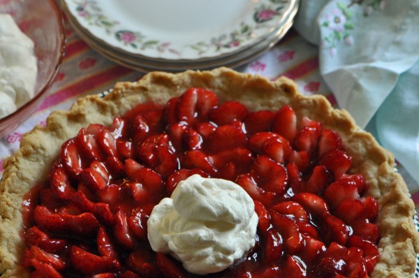 "Strawberry Glazed Pie with a large dollop of whipped cream in the center of the pie"