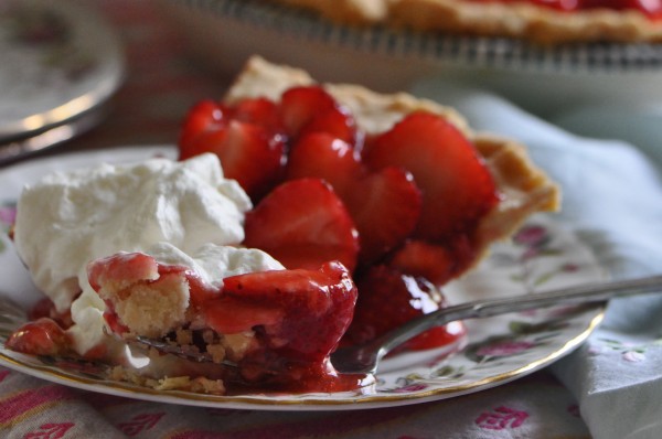 "A slice of strawberry glazed pie on a vintage gold trimmed floral dessert plate"