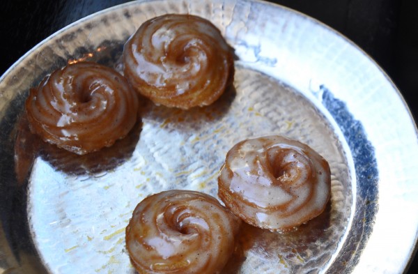 "Mini glazed donuts follow dessert at Cyrus Restaurant"