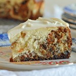 "A slice of Carrot Cake Cheesecake on a dessert plate"